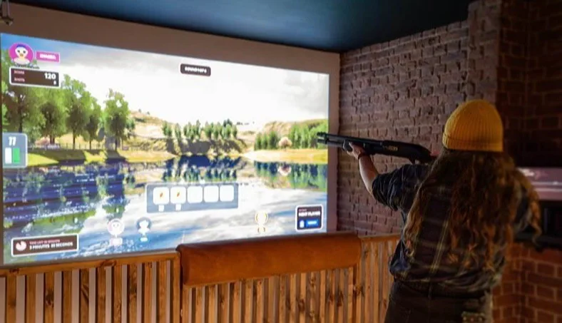 Guests playing ClayShot at an entertainment venue