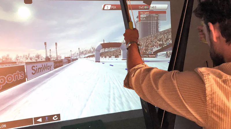 Biathlete skiing and shooting in the SimWay Biathlon simulator
